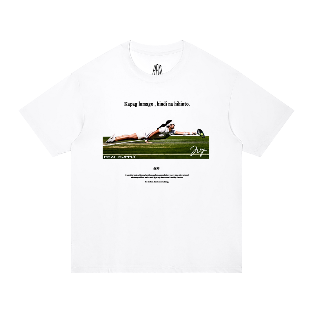 Heavyweight white cotton T-shirt featuring Alex Eala diving for a tennis ball beneath the inspirational Filipino phrase "Kapag lumago, hindi na hihinto." with a minimalist sports graphic celebrating determination, resilience, and Filipino pride.