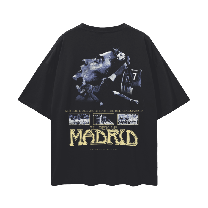 A black oversized T-shirt featuring multiple images of Cristiano Ronaldo in action while playing for Real Madrid. The text "Cristiano Ronaldo" is displayed prominently above the images, with a bold and striking design highlighting his iconic status