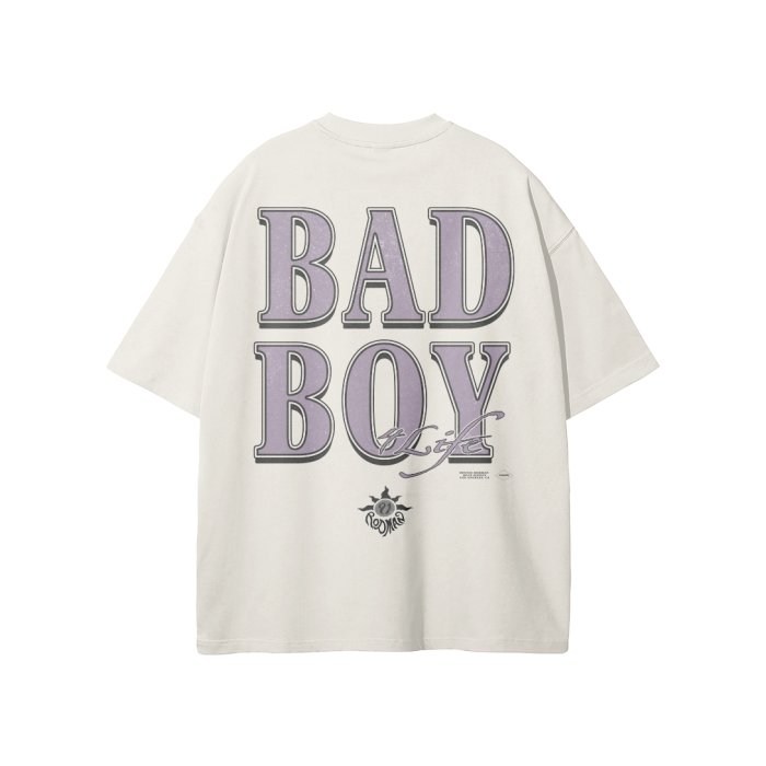 Vintage-style oversized t-shirt with the words 'BAD BOY' in large lavender letters on the back, with '4 LIFE' in a script font below. The design includes a small logo featuring a cartoon character at the bottom.