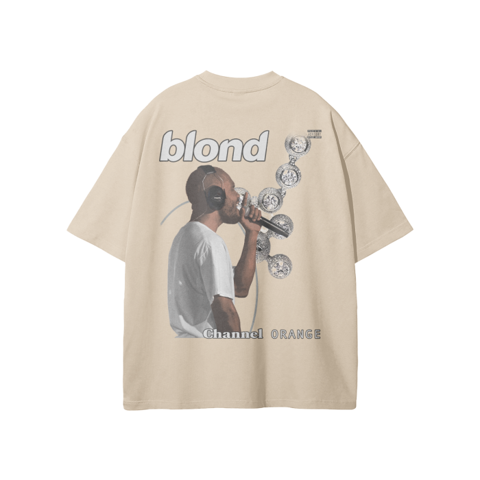 A Light Apricot-colored oversized t-shirt featuring a graphic design of Frank Ocean wearing headphones and singing into a microphone. The shirt includes the text "blond" at the top and "Channel Orange" at the bottom, with a series of album covers floating around Frank Ocean