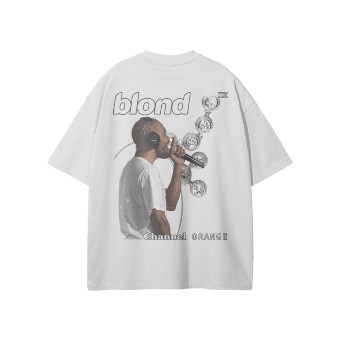 A Oat Grey-colored oversized t-shirt featuring a graphic design of Frank Ocean wearing headphones and singing into a microphone. The shirt includes the text "blond" at the top and "Channel Orange" at the bottom, with a series of album covers floating around Frank Ocean