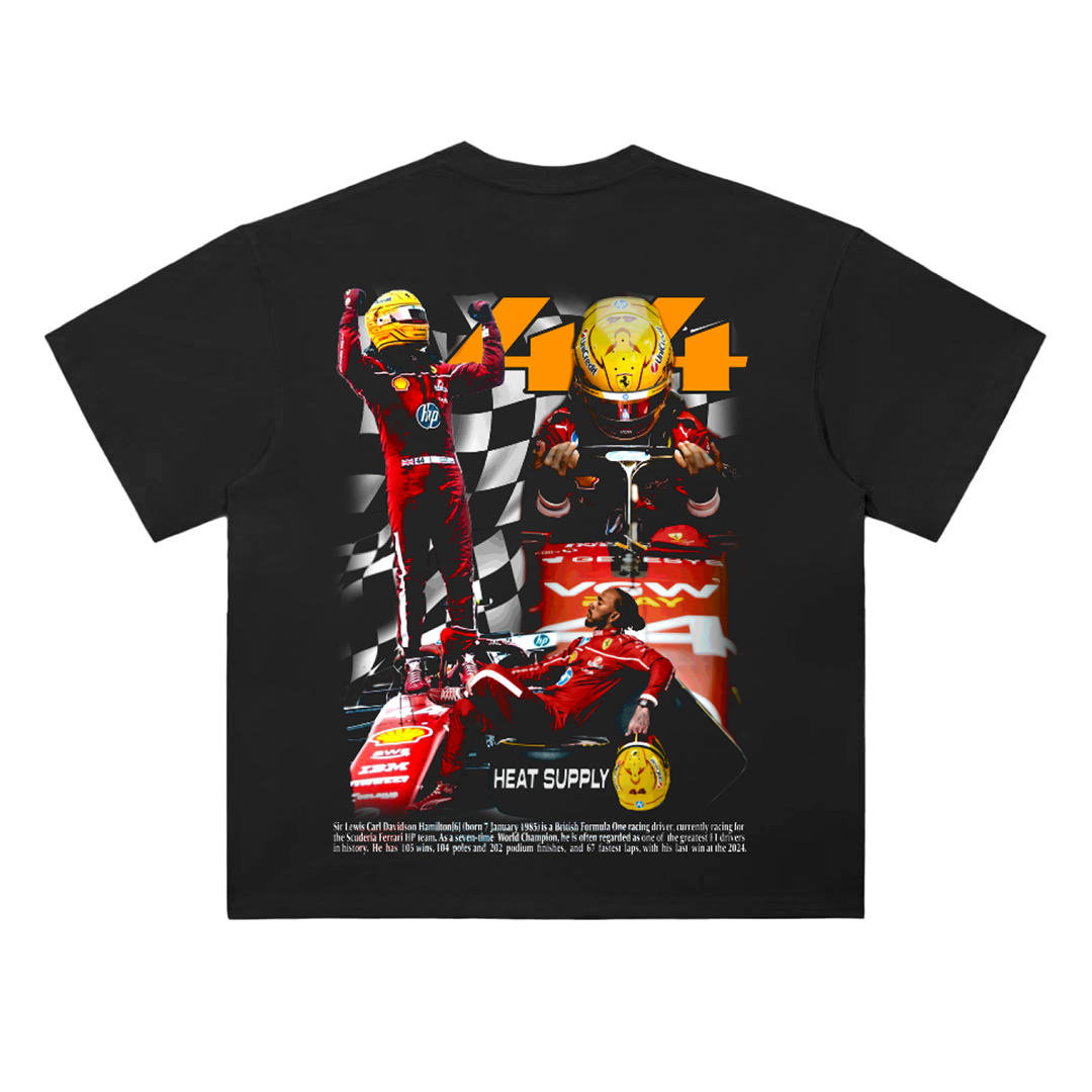 Black drop-shoulder graphic tee showing Lewis Hamilton celebrating on a Formula 1 car with helmet imagery, large “44” text, and layered racing visuals in red and black tones.