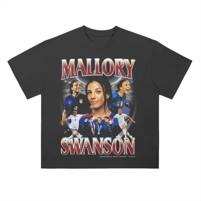 A black oversized t-shirt featuring a collage of Mallory Swanson, a prominent player for the US Women's National Soccer Team (UWNT). The design showcases multiple images of Swanson in action, with a larger central portrait surrounded by dynamic shots of her playing in various kits. The text "MALLORY SWANSON" is prominently displayed in bold red and white letters above and below the images