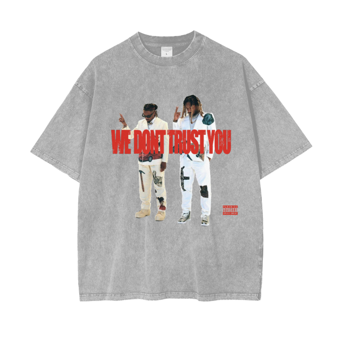 A apricot acid-wash oversized T-shirt featuring images of Metro Boomin and Future in stylish outfits. The text "WE DON'T TRUST YOU" appears in bold red letters across the chest, with a "Parental Advisory" label in the bottom right corner. The T-shirt has a vintage, streetwear vibe