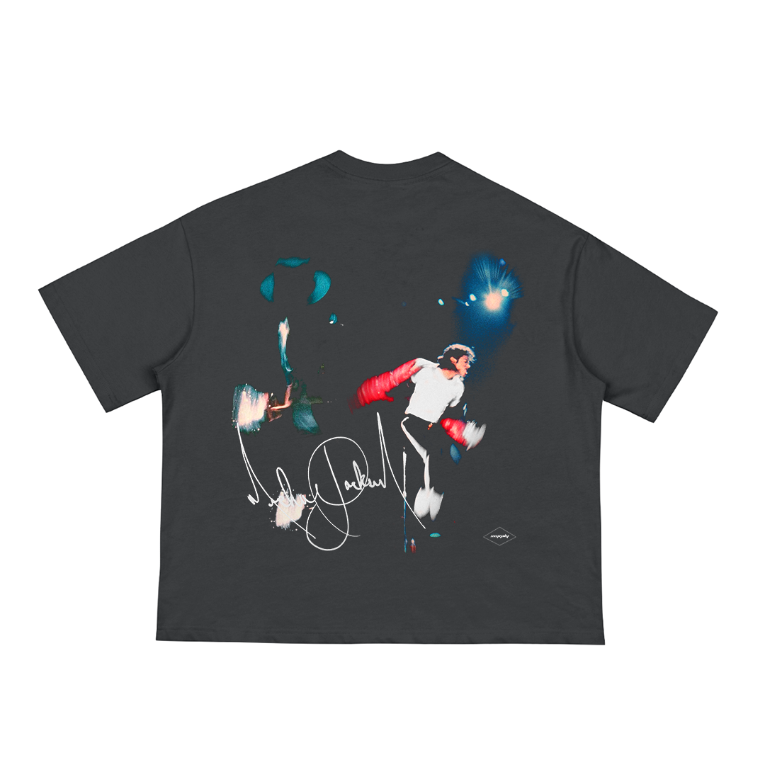 Black unisex t-shirt featuring a dynamic image of Michael Jackson mid-performance on stage with spotlights in the background, accented by a white signature graphic at the bottom.