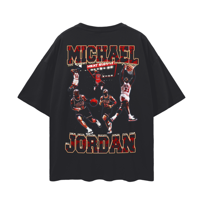A black oversized T-shirt featuring a dynamic collage of Michael Jordan in various iconic action poses during his time with the Chicago Bulls. The text "Michael Jordan" is prominently displayed in bold, red letters at the bottom, adding to the vibrant design.