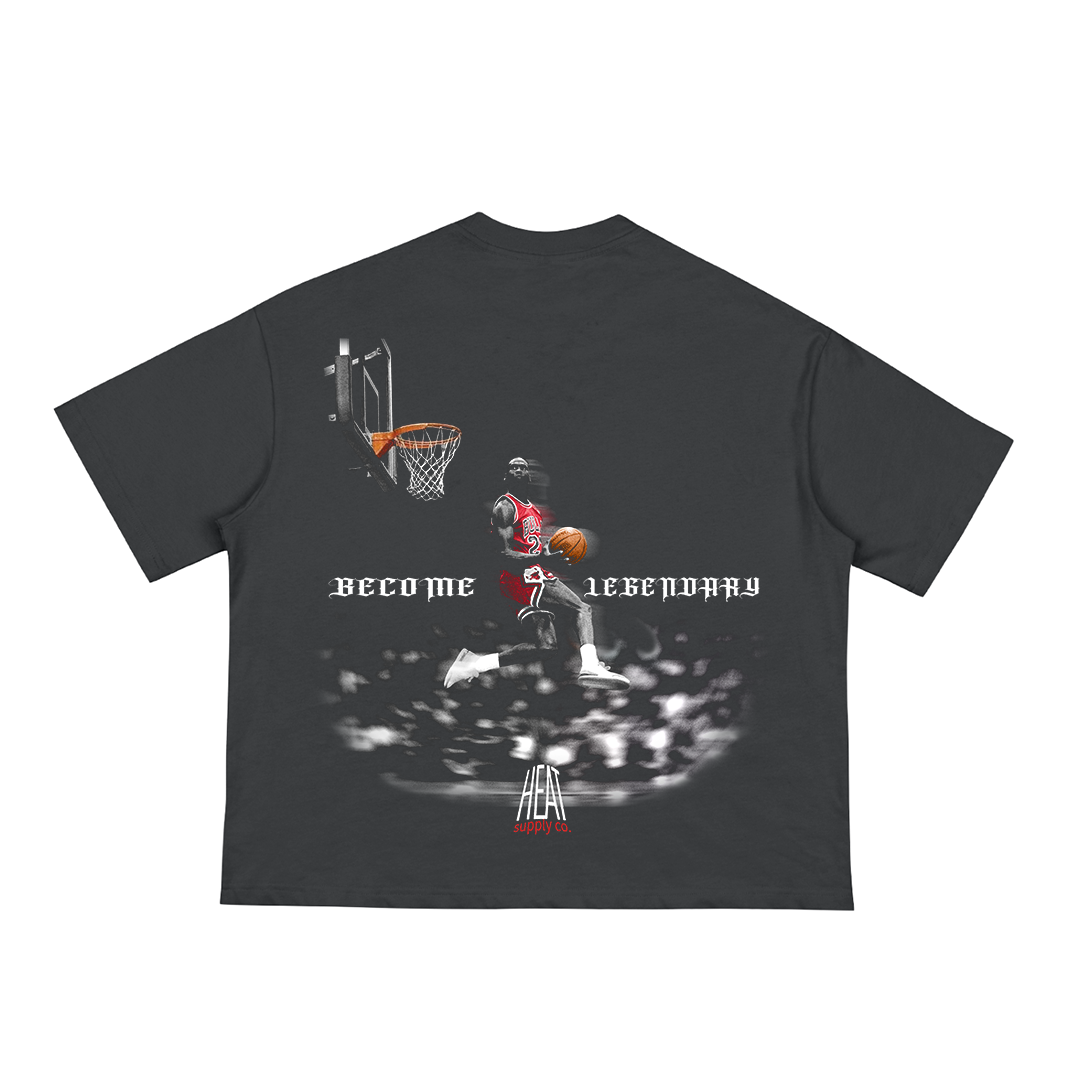 Black unisex t-shirt featuring a large graphic of Michael Jordan in a red Chicago Bulls jersey mid-air for a dunk, with the phrase "BECOME LEGENDARY" in gothic white text across the back and "HEAT Supply Co." logo below.