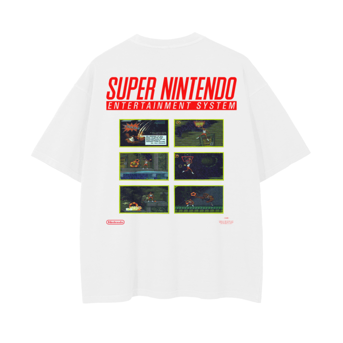 The back of the white oversized T-shirt displays a retro Super Nintendo theme with six screenshots from the Michael Jordan "Chaos in the Windy City" game. The images are arranged in two rows of three, with the bold "Super Nintendo Entertainment System" text in red at the top.
