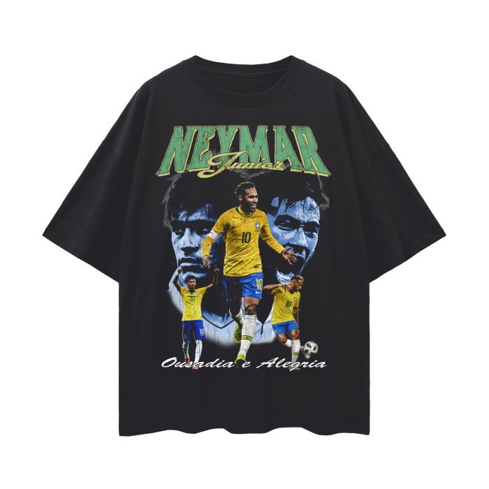 A black oversized t-shirt featuring a bold graphic design dedicated to Brazilian soccer star Neymar Jr. The design includes multiple images of Neymar in action wearing the iconic yellow and blue Brazil national team jersey, with the number 10 clearly visible. His name, "Neymar Junior," is displayed prominently at the top in large, stylized green and yellow text. Below the images, the phrase "Ousadia e Alegria" is written in elegant script, adding to the dynamic and celebratory feel of the shirt, perfect for
