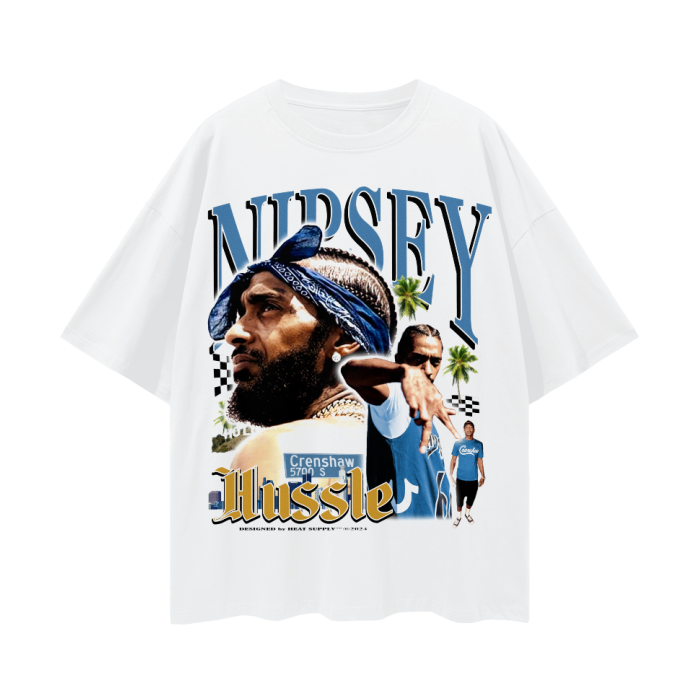 A white T-shirt featuring a graphic of Nipsey Hussle with a bandana on his head. The text "Nipsey" is written above the image in large letters, with "Hussle" below. The design includes images of Nipsey Hussle posing, palm trees, and a street sign that reads "Crenshaw 5700 S." The background has a checkered flag pattern and a few other symbolic elements.