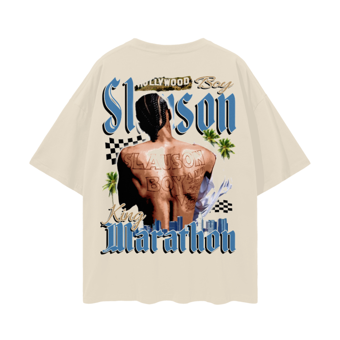 A beige T-shirt featuring a graphic of the back of Nipsey Hussle with braided hair and multiple tattoos, prominently displaying "Slauson Boy" across his back. The text "Slauson" is written above the image in large, stylized letters, with "King Marathon" below. The design includes palm trees and a cityscape, with a checkered flag pattern in the background.