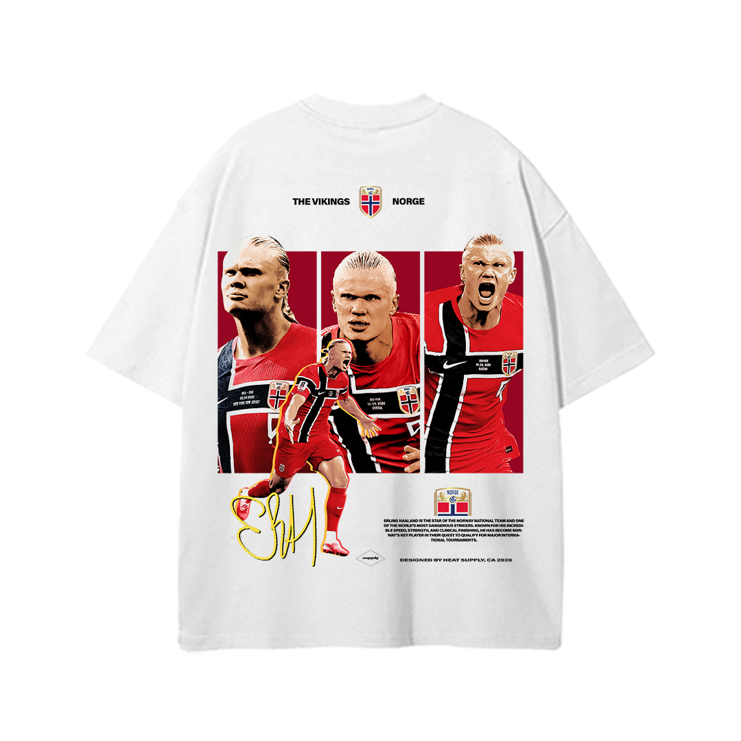 White heavyweight cotton standard fit T-shirt featuring a large back graphic of Erling Haaland in multiple action poses wearing the Norway national team kit with "THE VIKINGS • NORGE" text and signature-inspired artwork. Vintage-inspired football streetwear design for Norway fans.