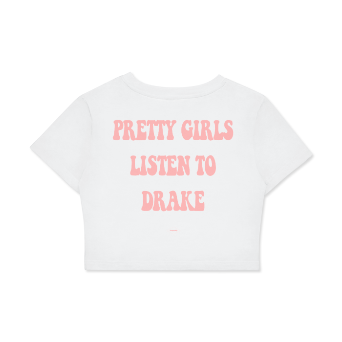 The back of a white cropped t-shirt with the text "PRETTY GIRLS LISTEN TO DRAKE" in bold, pink letters