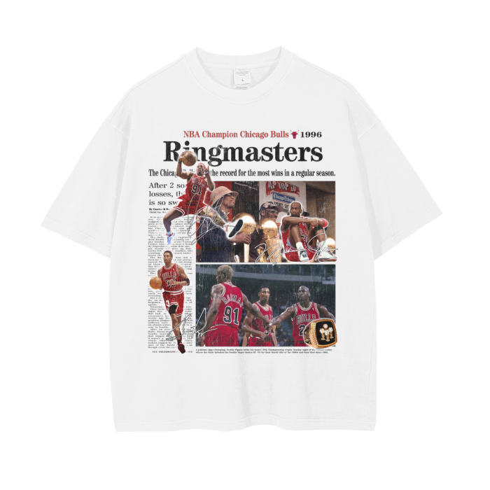 A white oversized t-shirt featuring a vintage newspaper-style collage of the 1996 NBA Champion Chicago Bulls. The design includes images of Michael Jordan and other players celebrating their championship victory, with the headline "Ringmasters" prominently displayed above
