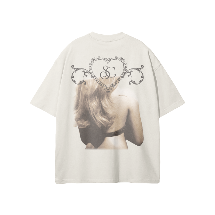 A cream-colored oversized t-shirt featuring a grayscale image of Sabrina Carpenter from the back, with a decorative heart-shaped design framing the initials "SC" at the top