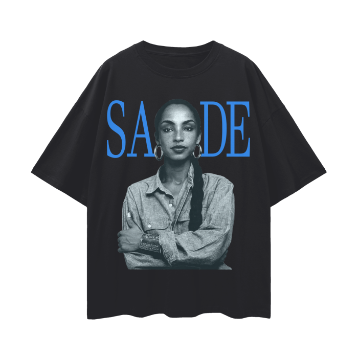A black oversized t-shirt featuring a black and white image of the iconic artist Sade, with her name "SADE" displayed in bold blue letters above the portrait