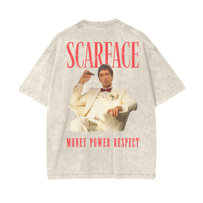 A beige oversized t-shirt featuring a graphic of Tony Montana from the movie "Scarface" sitting in a white suit with the words "SCARFACE" and "MONEY POWER RESPECT" in red above and below the image