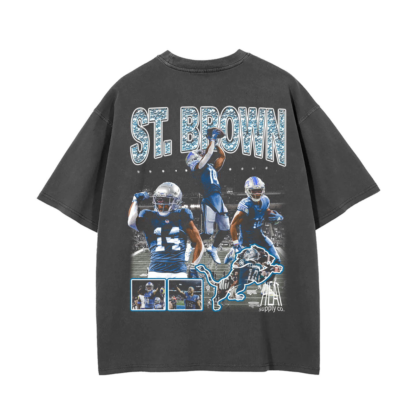 Grey oversized t-shirt featuring multiple action shots of Amon-Ra St. Brown, a wide receiver for the Detroit Lions. The text 'ST. BROWN' is printed across the top with a lion mascot graphic and additional player images below
