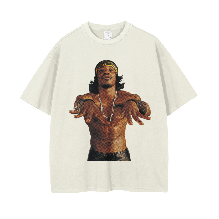 Cream-colored oversized t-shirt featuring a large image of André 3000, shirtless, with a confident pose and wearing a headband, necklaces, and bracelets. The image captures his distinctive style and charismatic personality.