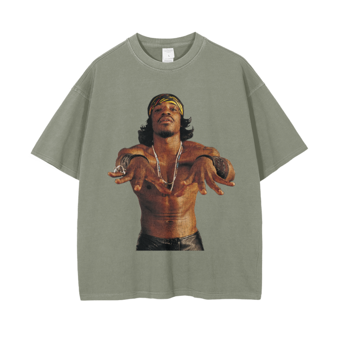 Grey-colored oversized t-shirt featuring a large image of André 3000, shirtless, with a confident pose and wearing a headband, necklaces, and bracelets. The image captures his distinctive style and charismatic personality.