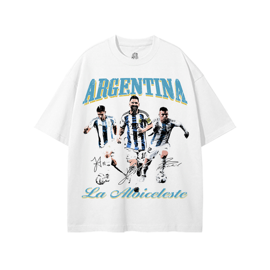 White heavyweight Argentina soccer graphic tee featuring vintage-style La Albiceleste artwork with multiple Argentina football player graphics and blue-and-gold “Argentina La Albiceleste” typography.