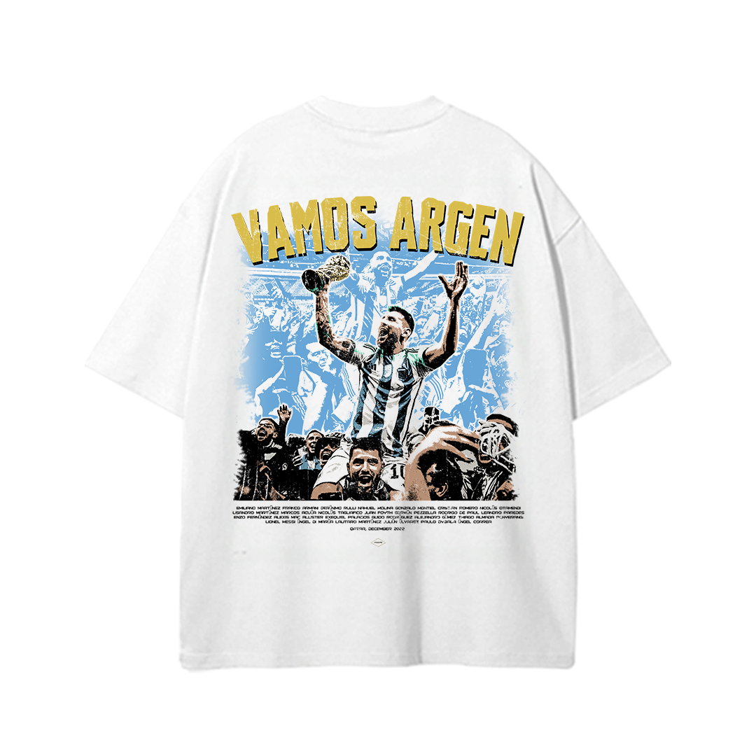 White oversized Argentina World Cup t-shirt featuring championship celebration artwork with crowd graphics, trophy imagery, and bold “Vamos Argen” typography inspired by Argentina’s World Cup victory.