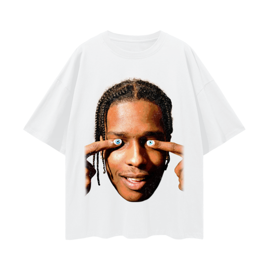 White oversized t-shirt featuring a large image of A$AP Rocky's face. He is smiling and holding his fingers to his temples, with eyes printed on his fingernails, creating a playful and surreal effect
