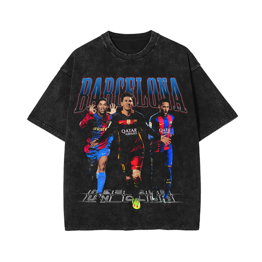 "Vintage-style Barcelona soccer tee featuring iconic players Ronaldinho, Lionel Messi, and Neymar Jr. The design is set against a black acid-wash background with bold 'Barcelona' text in blue and red across the top. Each player is depicted in vibrant colors, wearing their respective Barcelona jerseys, creating a nostalgic tribute to the team."