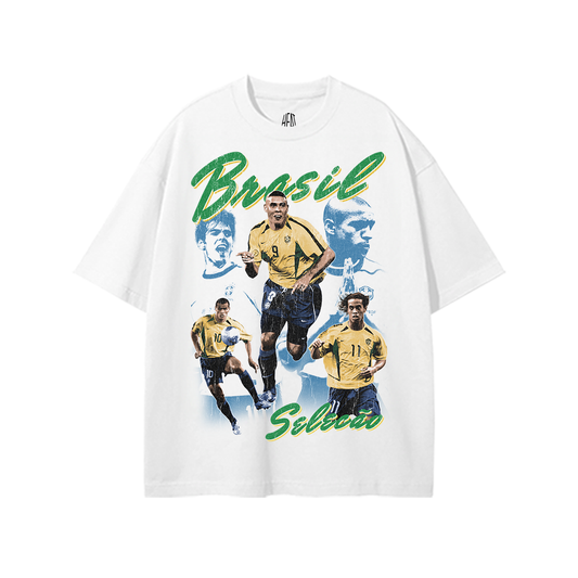White heavyweight Brazil soccer graphic tee featuring vintage-style Brazilian national team player collage artwork with green and yellow “Brasil Seleção” typography.