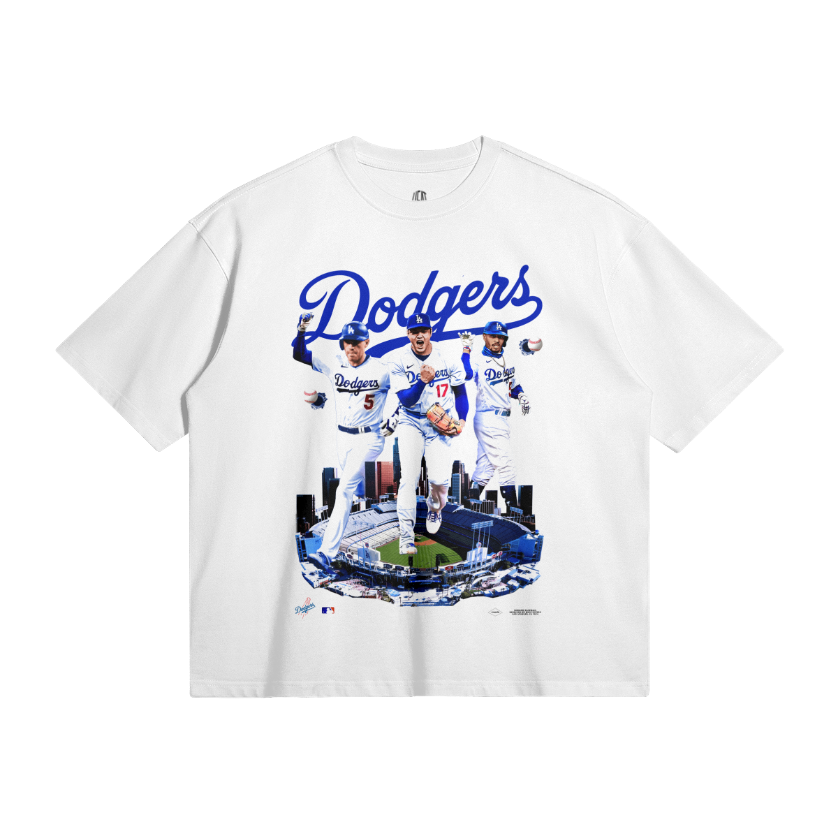 An oversized white t-shirt showcasing a collage of Los Angeles Dodgers players, including Shohei Ohtani, Mookie Betts, and Freddie Freeman. The word "Dodgers" is prominently displayed above the images, with Dodger Stadium depicted at the bottom.