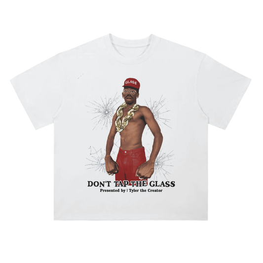 Black graphic tee with a shirtless man in red leather pants and heavy gold chains, standing in front of cracked glass visuals and the phrase “DON’T TAP THE GLASS” underneath.

