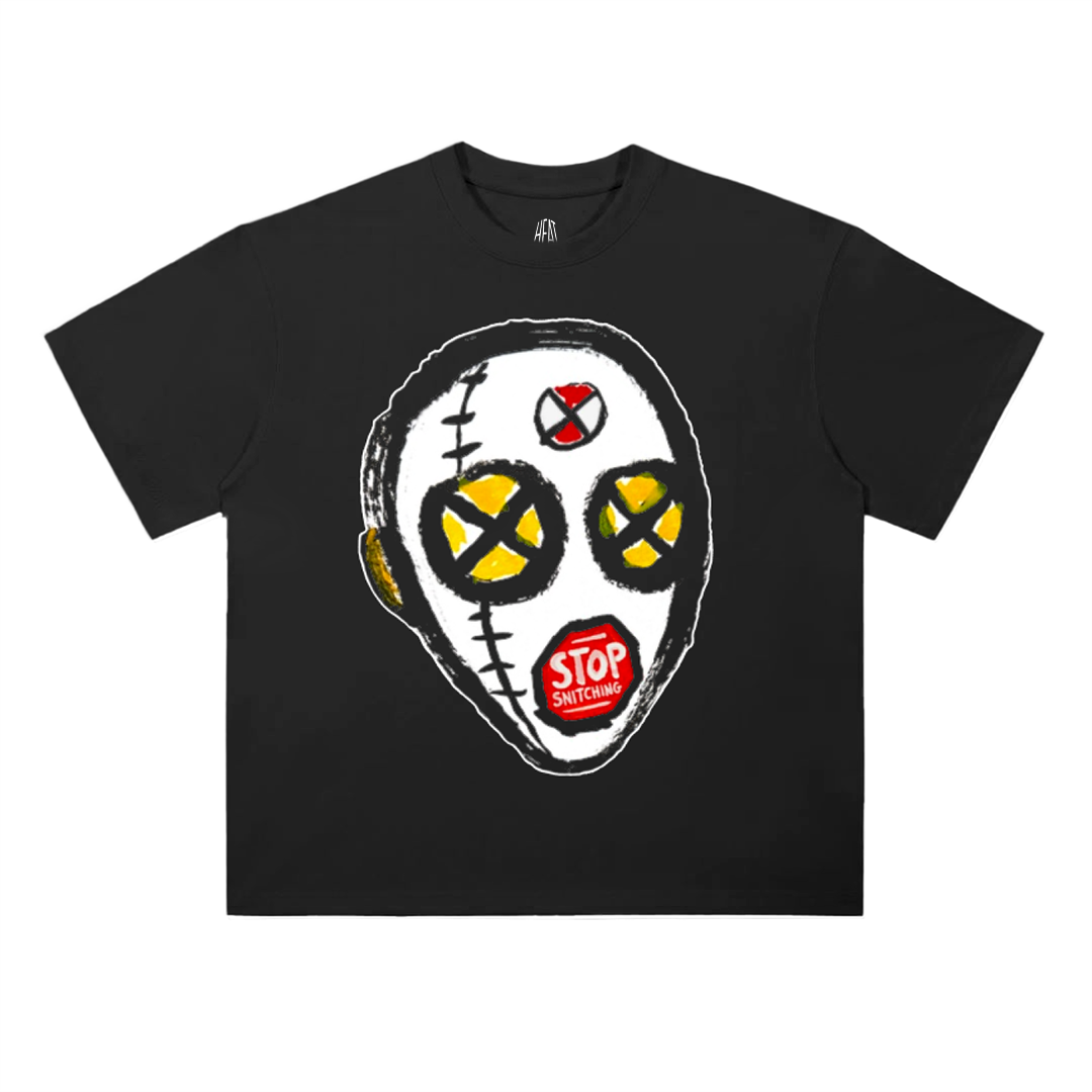 Black oversized drop shoulder T-shirt featuring a bold illustrated stitched mask graphic with X-shaped eyes and a red “Stop Snitching” detail on the mouth, inspired by A$AP Rocky album art visuals.