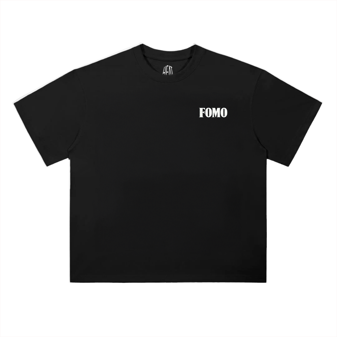 Black heavyweight cotton T-shirt featuring a minimalist "FOMO" chest graphic on the front and a bold oversized "Fear Of Missing Out" typography design across the back, inspired by modern hip-hop streetwear aesthetics.