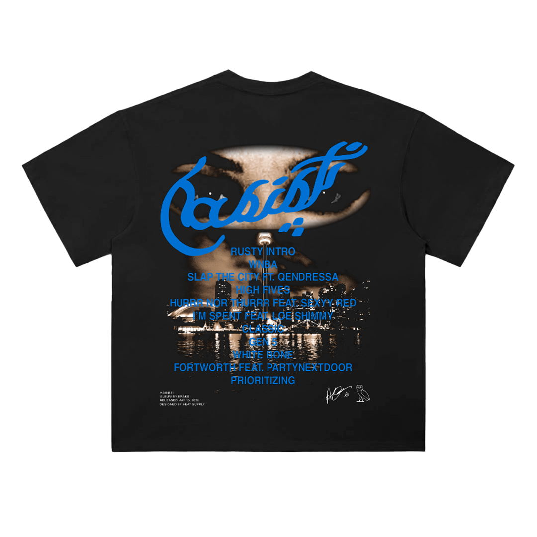 Black oversized drop-shoulder T-shirt featuring a front graphic of eyes framed with tape and a small script detail, with a large back design combining layered eye imagery, blue script text, and tracklist-style typography inspired by Drake/Iceman aesthetics