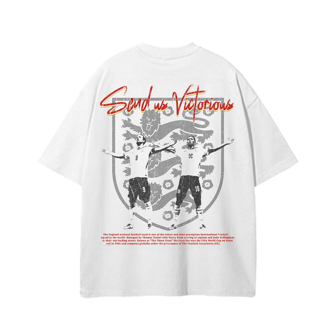 White heavyweight England football graphic t-shirt featuring Harry Kane and Jude Bellingham celebrating in front of the iconic Three Lions crest with bold "Send Us Victorious" script across the top and vintage-inspired England national team artwork on the back.