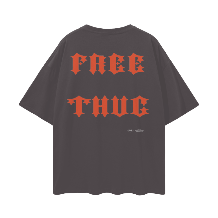  The back of the t-shirt features bold red text that reads "FREE THUG" in an old-school gothic font.