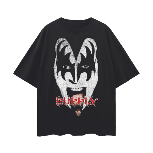 A black oversized drop-shoulder T-shirt featuring a bold, distressed graphic of Gene Simmons from Kiss, complete with his signature face paint and tongue out. The word "SUPPLY" is printed in red grunge-style text below the face. The tee exudes classic rock energy and is perfect for streetwear looks.