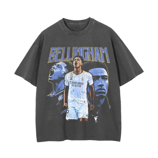A vintage wash, oversized black tee featuring a bold graphic of Jude Bellingham, with three images of the soccer star in various poses, overlaid with his name in large, yellow and blue text. The shirt has a drop shoulder design and washed texture for a streetwear aesthetic.