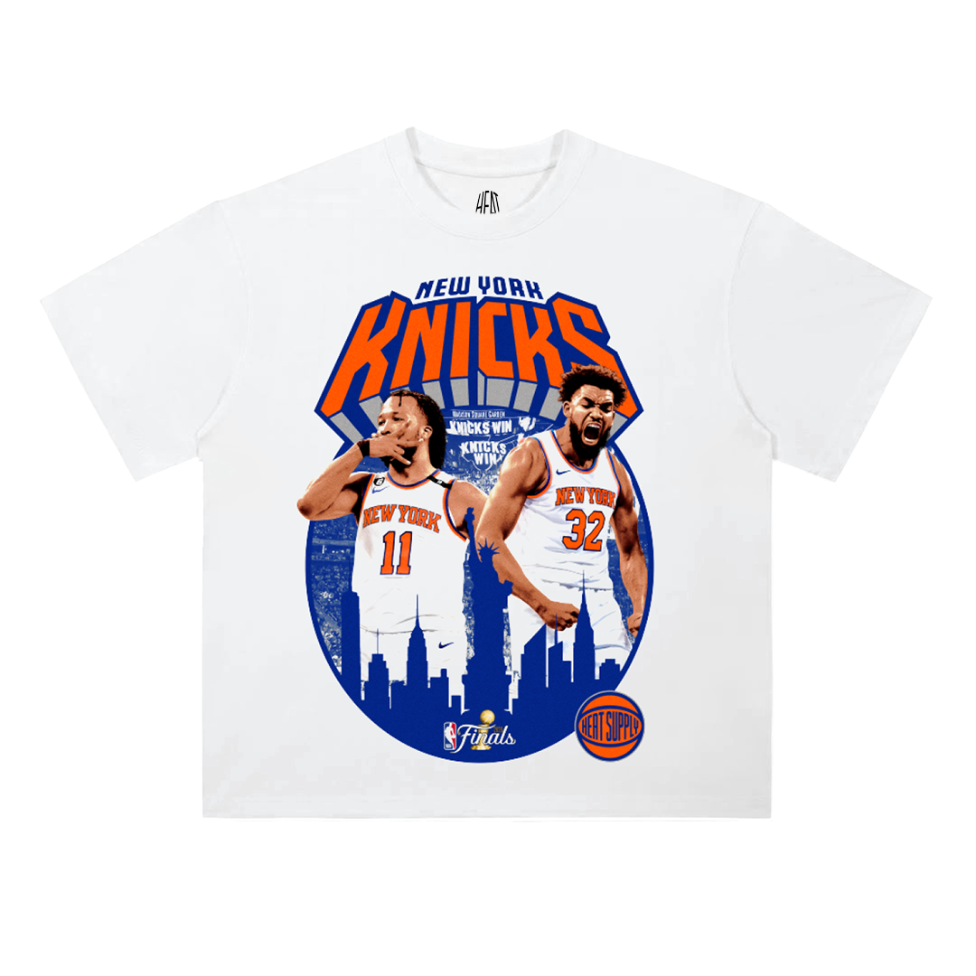 Front and back mockup of a white heavyweight New York Knicks NBA Champions 2026 t-shirt featuring Jalen Brunson and Karl-Anthony Towns on the front with a New York skyline graphic, and a championship trophy roster design on the back listing the 2026 Knicks team.