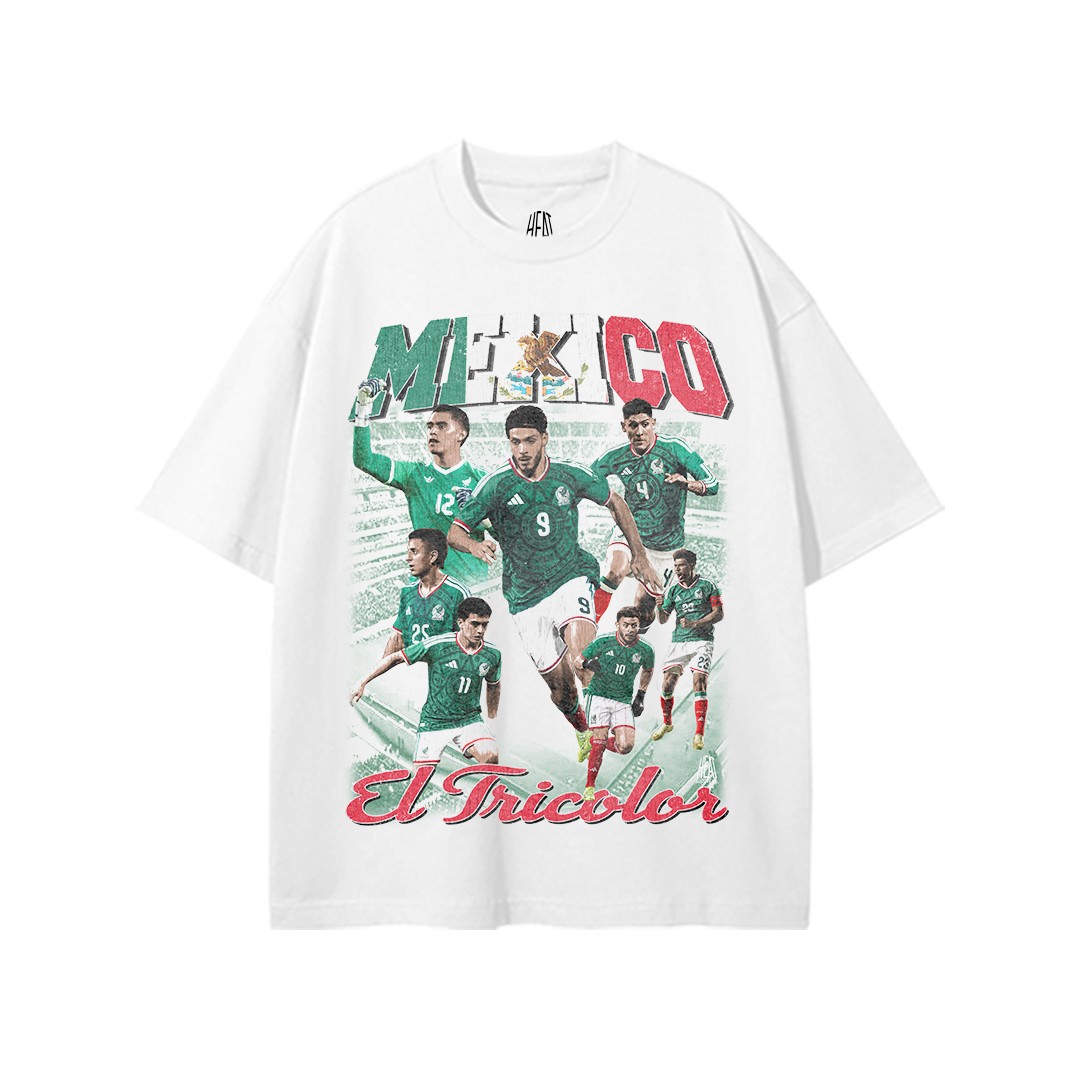 White heavyweight Mexican National Soccer Team graphic T-shirt featuring a vintage-style El Tricolor player collage with bold Mexico lettering in green, white, and red and “El Tricolor” script across the bottom.
