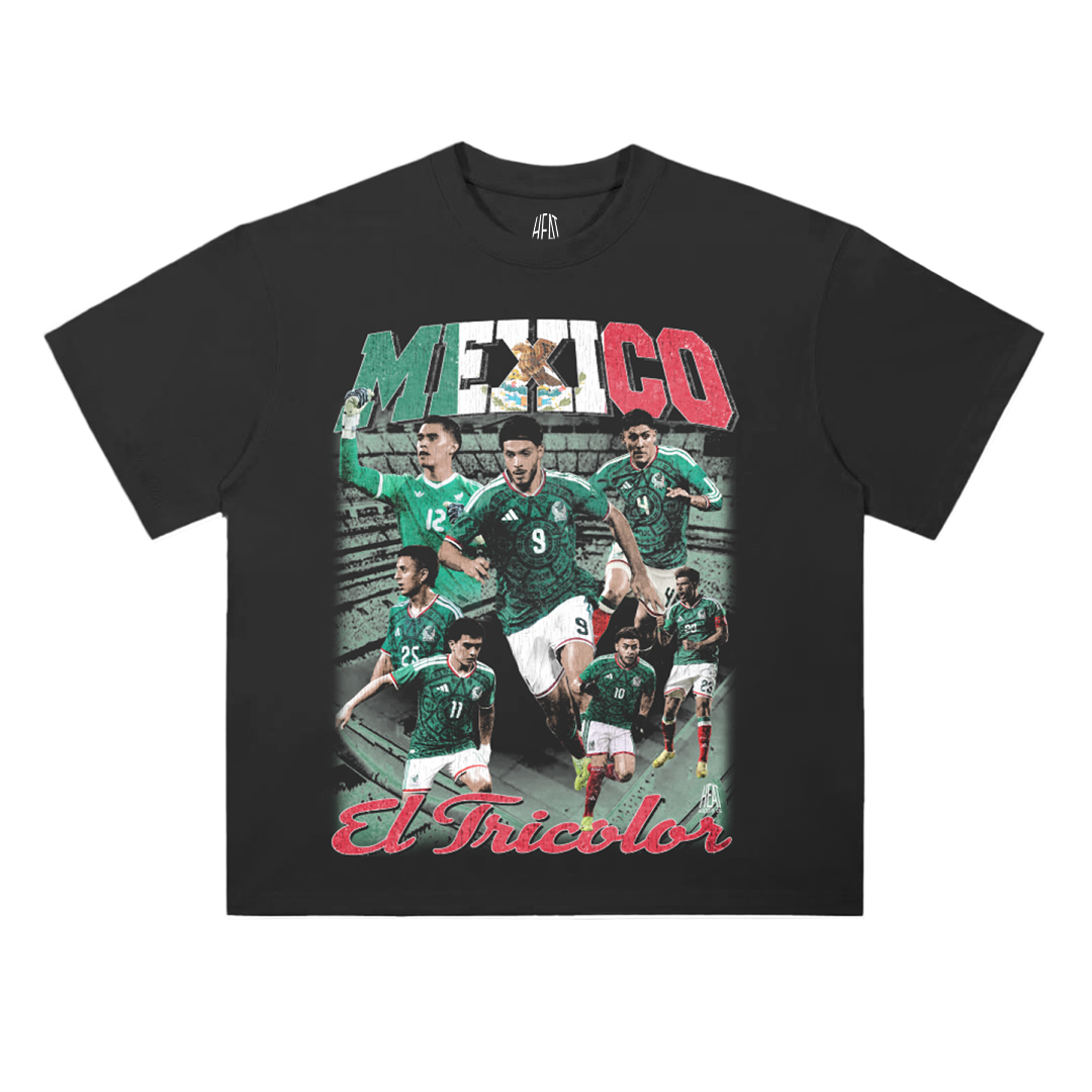 Black heavyweight Mexican National Soccer Team graphic T-shirt featuring a vintage-style El Tricolor player collage with bold Mexico lettering in green, white, and red and “El Tricolor” script across the bottom.
