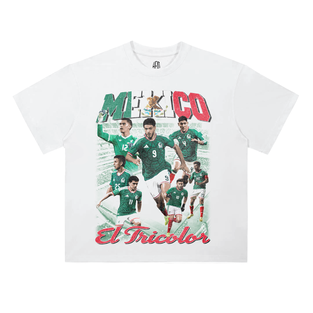 White heavyweight Mexican National Soccer Team graphic T-shirt featuring a vintage-style El Tricolor player collage with bold Mexico lettering in green, white, and red and “El Tricolor” script across the bottom.