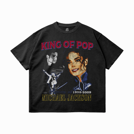 Black oversized unisex t-shirt featuring a distressed graphic collage of Michael Jackson with “KING OF POP” in red, a portrait of MJ, silhouette performance shots, and the text “In memory of 1958–2009” and “MICHAEL JACKSON” in gold below.