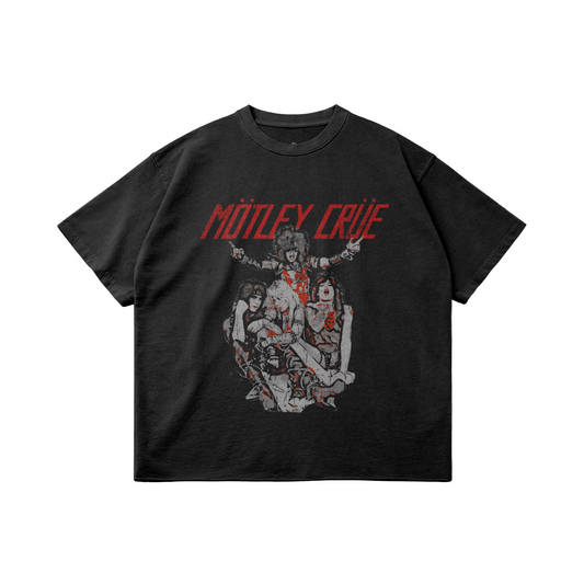 A black oversized t-shirt featuring a vintage-style graphic of the rock band Mötley Crüe. The design showcases the four band members in their classic 1980s glam metal attire, with the band's name "Mötley Crüe" displayed in bold red text above them. The graphic has a distressed look, giving the shirt a retro and worn-in vibe, perfect for fans of classic rock.