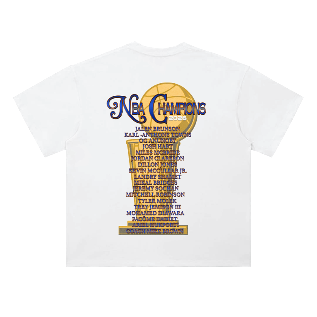 Front and back mockup of a white heavyweight New York Knicks NBA Champions 2026 t-shirt featuring Jalen Brunson and Karl-Anthony Towns on the front with a New York skyline graphic, and a championship trophy roster design on the back listing the 2026 Knicks team.
