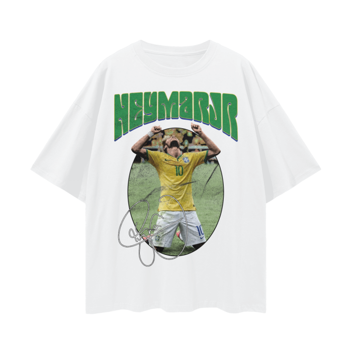 A white oversized t-shirt featuring Neymar Jr. in a celebratory pose with his hands raised. The text "NEYMAR JR" is written in large green letters above the image, and his signature is displayed below the image.