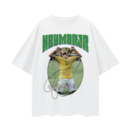 A white oversized t-shirt featuring Neymar Jr. in a celebratory pose with his hands raised. The text "NEYMAR JR" is written in large green letters above the image, and his signature is displayed below the image.