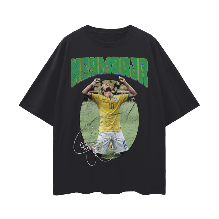 A black oversized t-shirt featuring Neymar Jr. in a celebratory pose with his hands raised. The text "NEYMAR JR" is written in large green letters above the image, and his signature is displayed below the image.