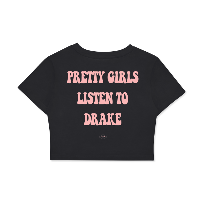 The back of a black cropped t-shirt with the text "PRETTY GIRLS LISTEN TO DRAKE" in bold, pink letters