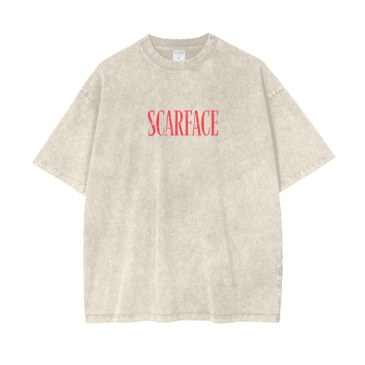 A beige oversized t-shirt with the word "SCARFACE" printed in red across the chest on a plain background